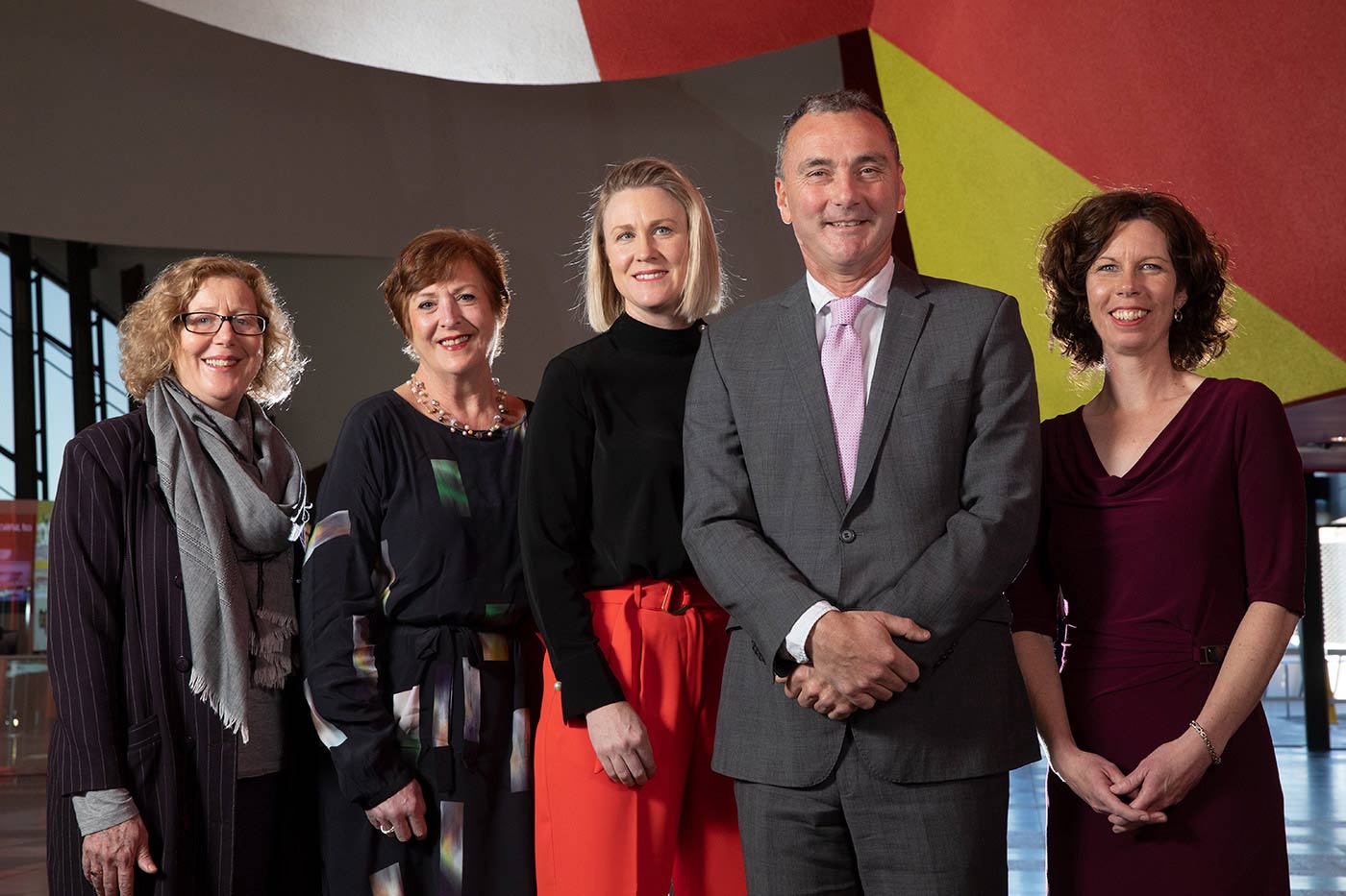 Four women and one man pose for the camera.
