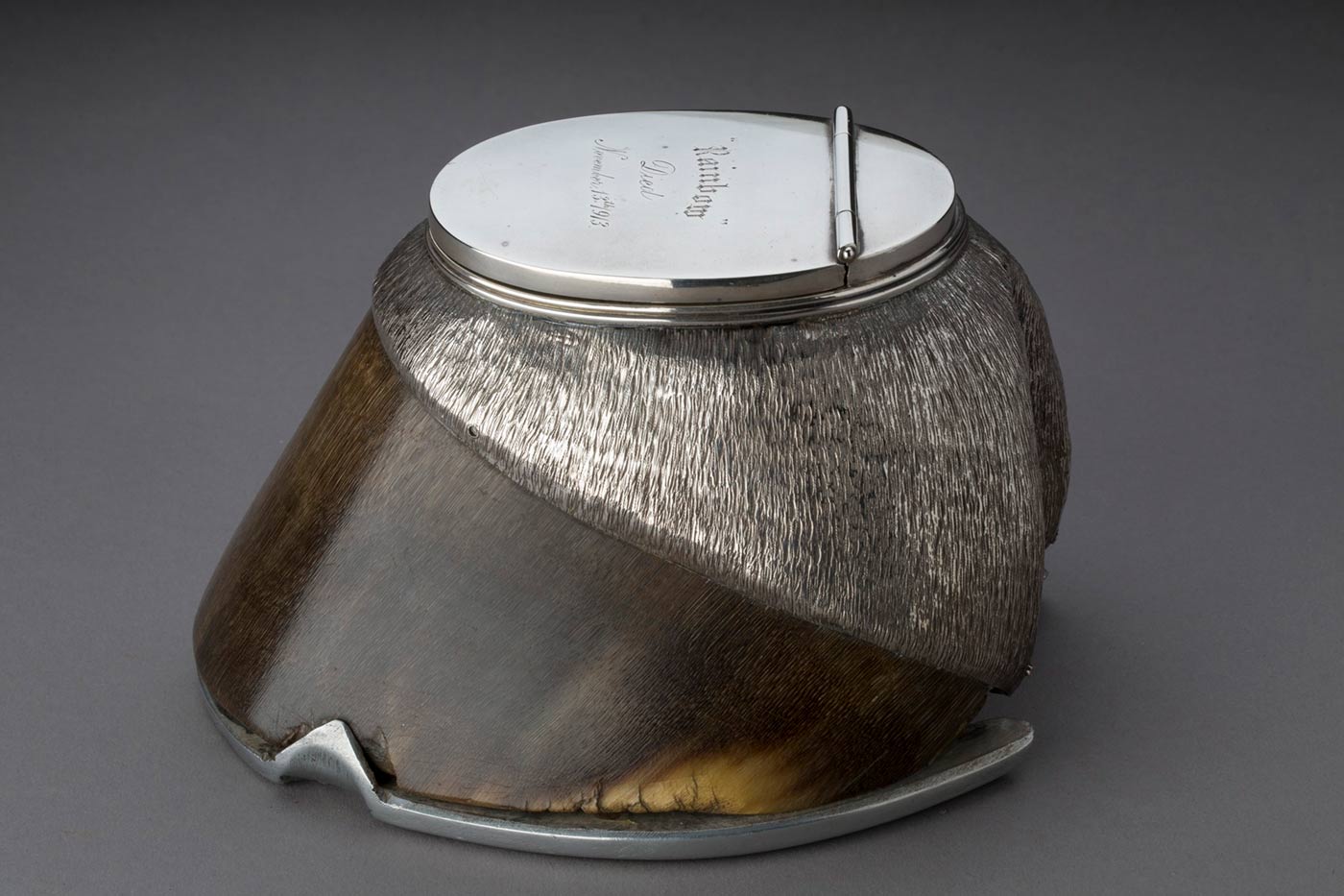 Detail of the inscription ‘Rainbow died November 13th 1913’ on a silver inkwell set into a horse’s hoof.