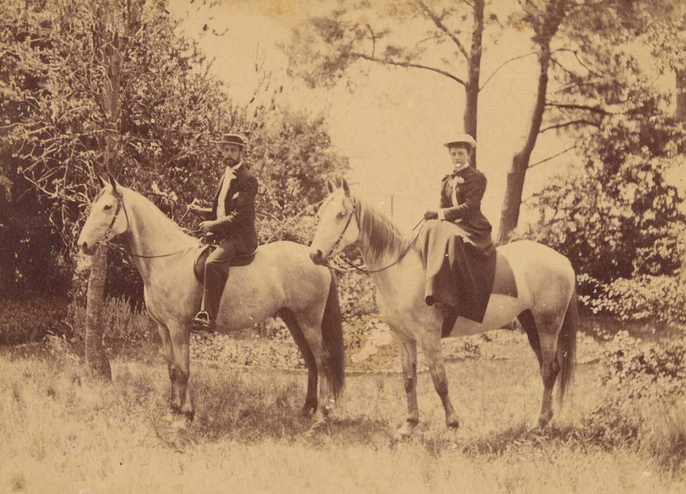 A black and white photograph that depicts William Hugh Anderson and Frances Lilian Faithfull mounted on light-coloured horses.