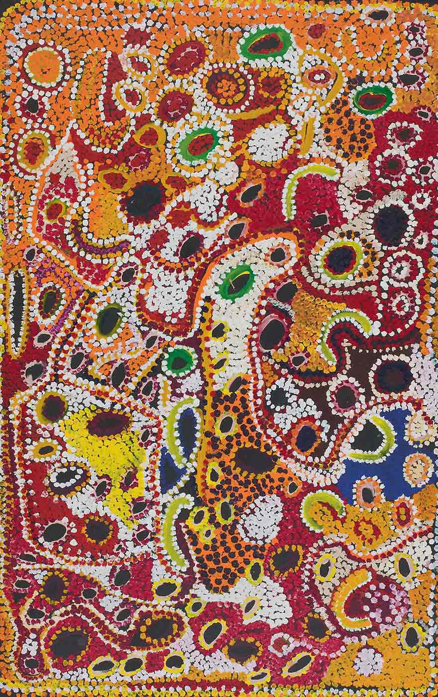 A multicolour dot painting on canvas with a plain blue section towards the lower right side. The painting has circles or ovals in brown, black or red with dotted or plain edges in green, yellow red or white. There are a C shapes in light green or yellow edged 'ith dots of white. The background is filled with multicoloured dots with a section of orange at the top, yellow at the left side plus dots in red, maroon, green, black white and brown.
