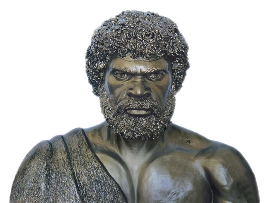 Bronze statue of a bearded man with a cloth draped over his torso.