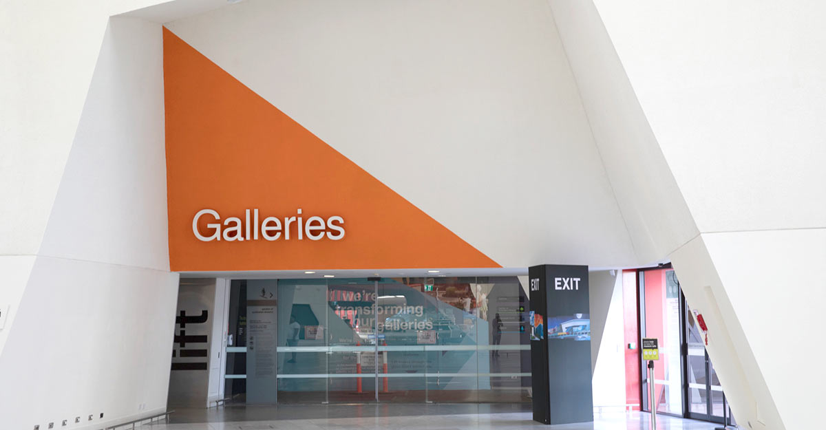 Glass sliding door entrance to a Galleries section.