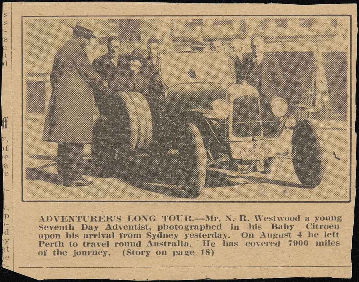 A newspaper clipping of a man sitting at the wheel of a stationary automobile surrounded by a group of men. Underneath the image is a caption that reads ‘ADVENTURER’S LONG TOUR.—Mr. N. R. Westwood a young Seventh Day Adventist, photographed in his Baby Citroen upon his arrival from Sydney yesterday. On August 4 he left Perth to travel round Australia. He has covered 7900 miles of the journey. (Story on page 18).