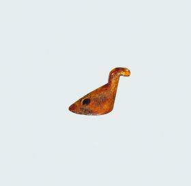 Bird figure Bird figure made of bone that represents a water bird resting on a flat oval base.