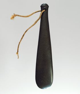162.jpg Flat club made of dark basalt, with hole drilled at the grip end with a strap made of twisted twine.