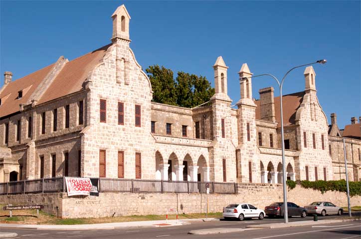 A large heritage sandstone building with a sign that reads 'Fremantle Arts Centre'.