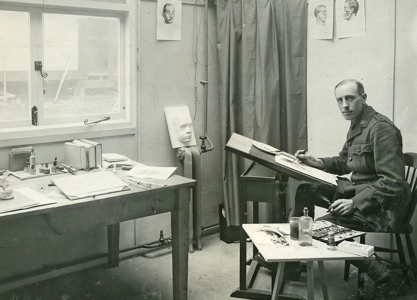 Portrait of a man sitting in his artist's studio.