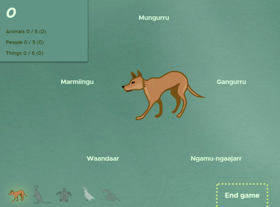 Screenshot of a digital game featuring a dingo surrounded by words in the Aboriginal language Guugu Yimidhirr.