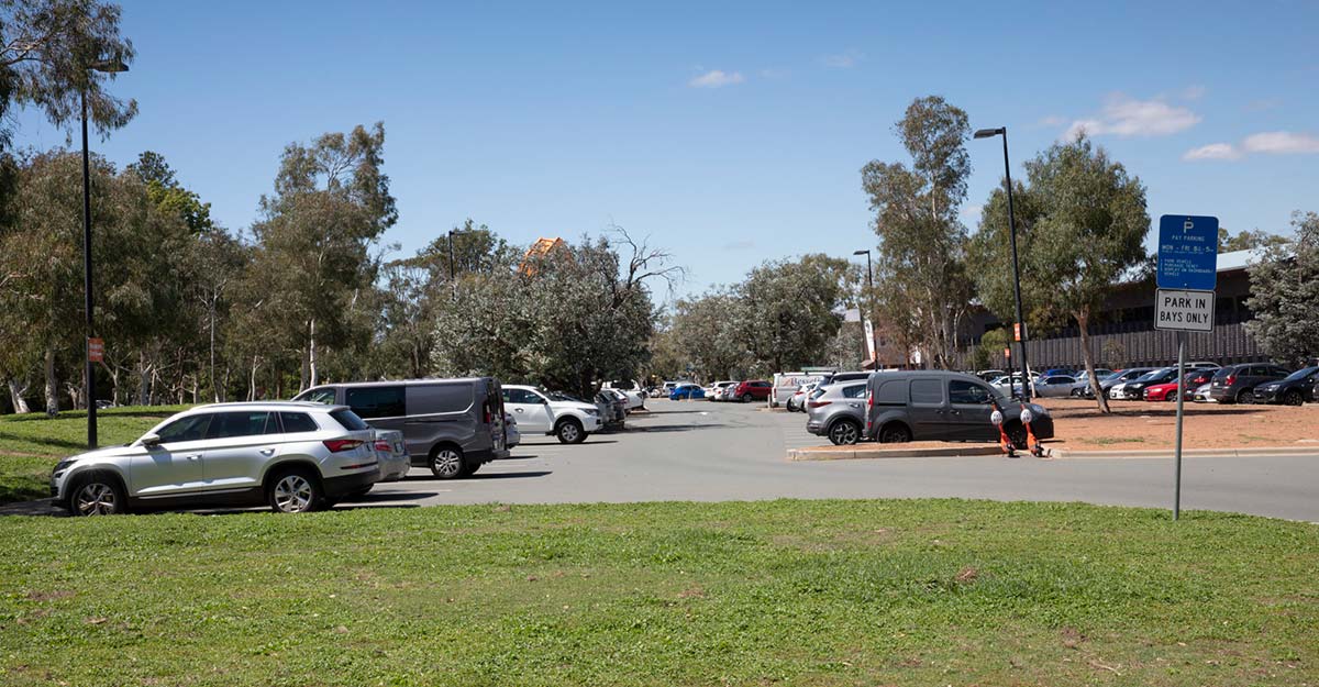 View of a large car park surrounded by trees.