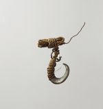 Fishhook matau fishhook made of snail shell with thin twisted cord.