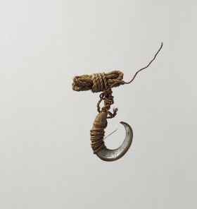 Fishhook matau fishhook made of snail shell with thin twisted cord.