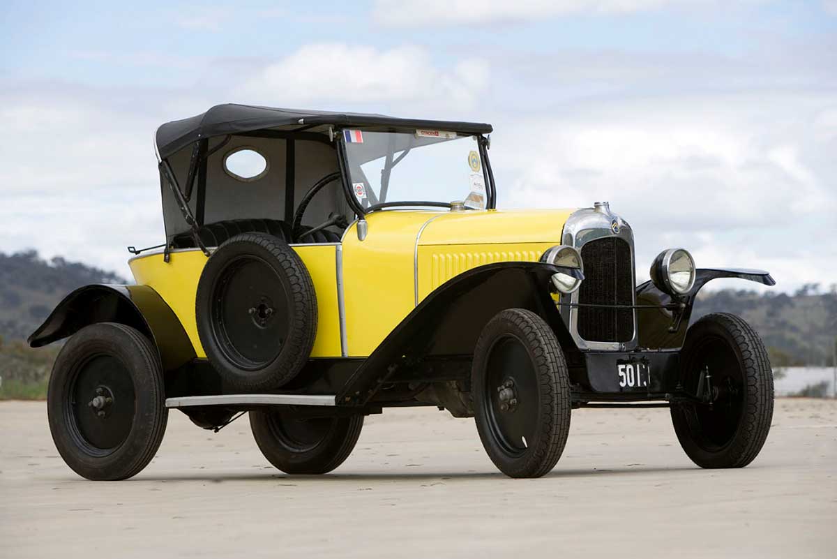 Yellow Citroen car with black hood.