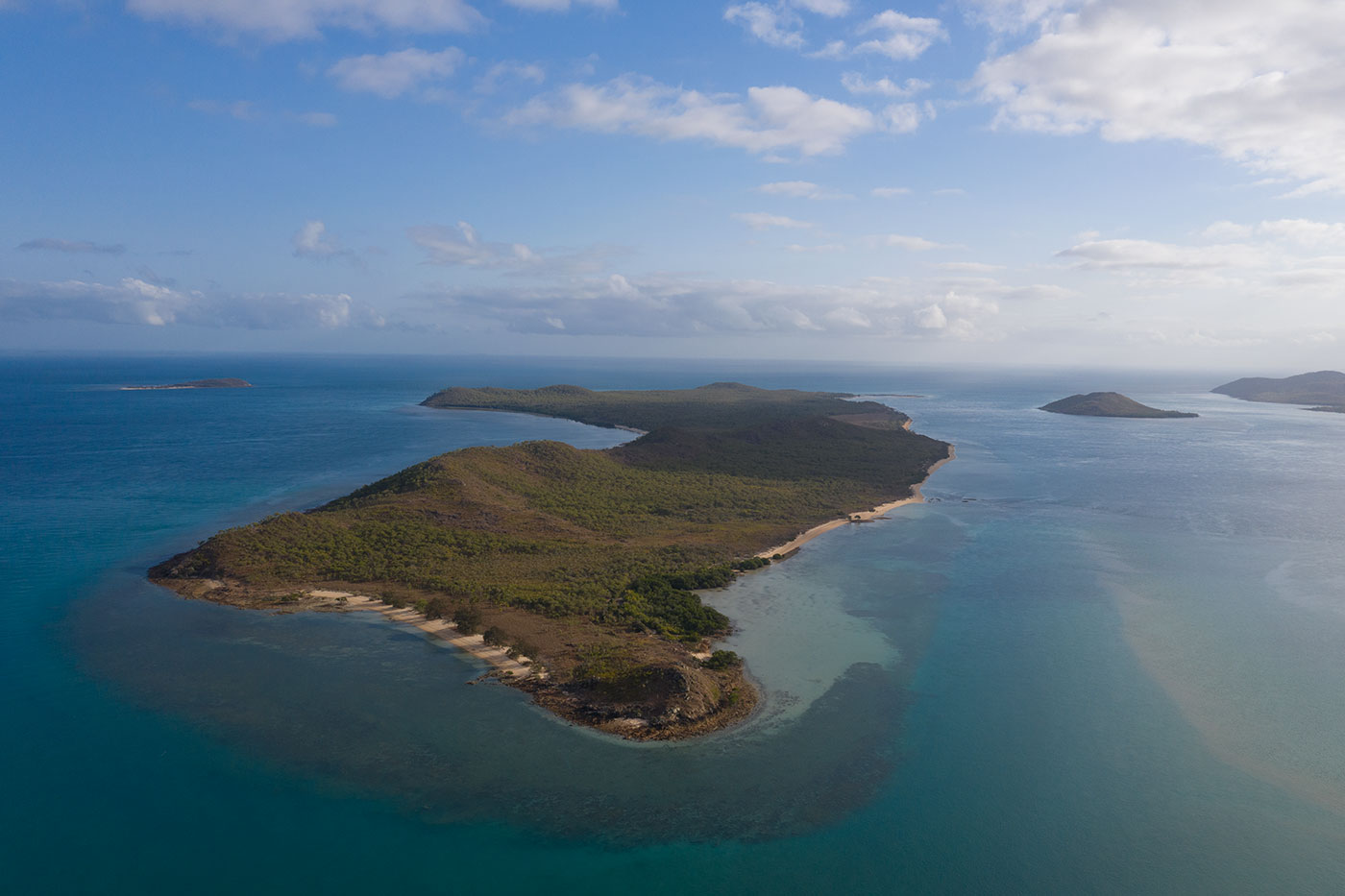 Colour photo of an aerial view of islands surrounded by ocean.