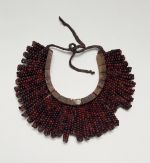 Breast ornament (gorget) Breast plate, formed into a crescent-shaped base made of light soft wood tied together. The breast is covered over with the beautiful red and black tropical peas.