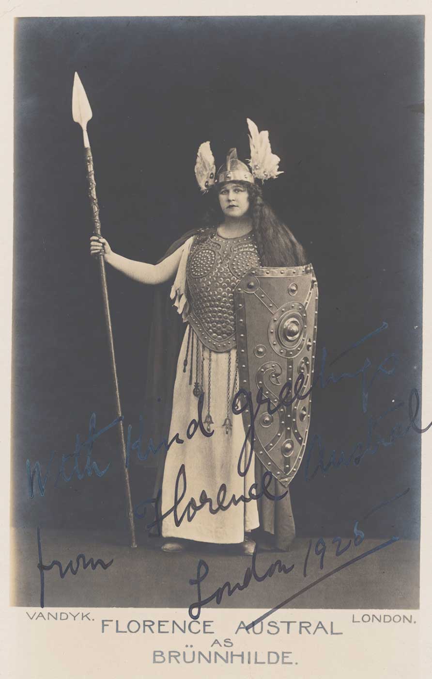 Studio portrait of Florence Austral wearing a two-pronged helmet and carrying a spear and shield, in costume as Brunnhilde.