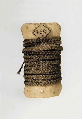 112 Cord made of made from light brown plant fibres and wound round a thin piece of cardboard.