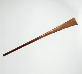172.jpg Club made of brown wood that is slightly rhomboid shaped at one end and ornamented with dots and diagonal, zigzag, and horizontal lines. Both ends separated by eight bulged rings.