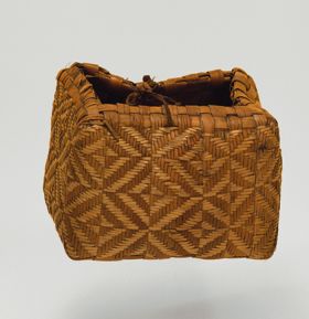 Basket kato Basket made of pandanus leaves of yellowish and brown strips with a torn handle of plaited coconut fibre.