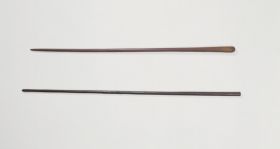187.jpg Clubs made of brown, heavy wood, one of nearly black wood.