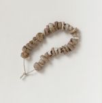 Shell discs tuinga kula Jewellery & Adornment consisting of thirty-one white and beige-coloured shell discs arranged on a string.