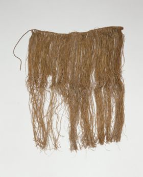 Skirt Skirt or apron made from fine shred of plantain leaf, dyed and knotted to a string that fastens around the waist.