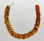 312.jpg Feathered necklace that consists of yellow and red feathers, tightly arranged in circles.
