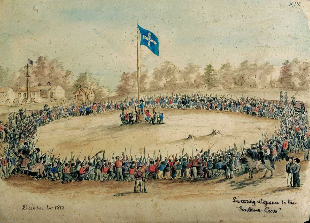 Hundreds of men encircle flag pole with Eureka flag at the top.