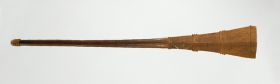 173.jpg Club made of brown wood that is rhomboid shaped at one end and ornamented with rhomboid, triangular, and linear patterns at the other. Ornamented part is divided by four groups of bulged rings.